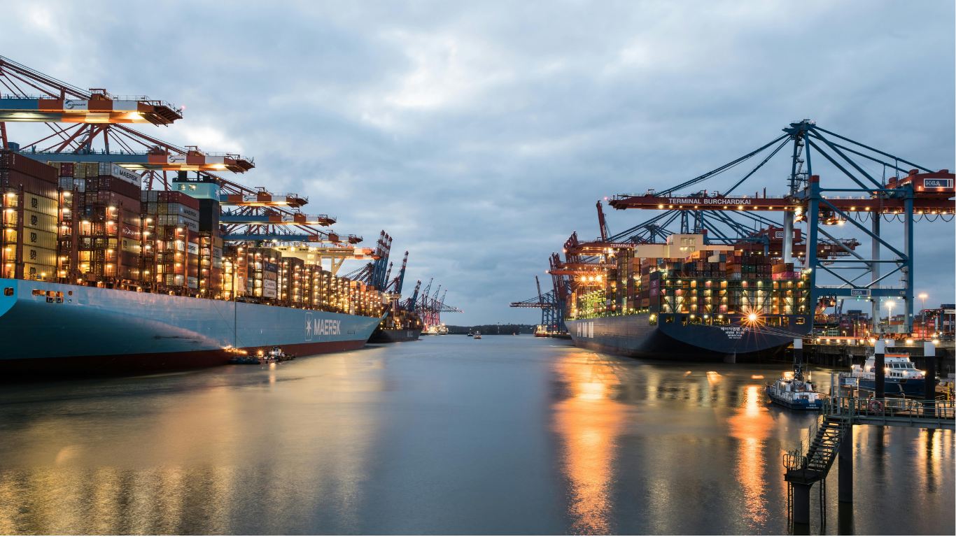 Container terminal at dusk with vessels loading — international food logistics